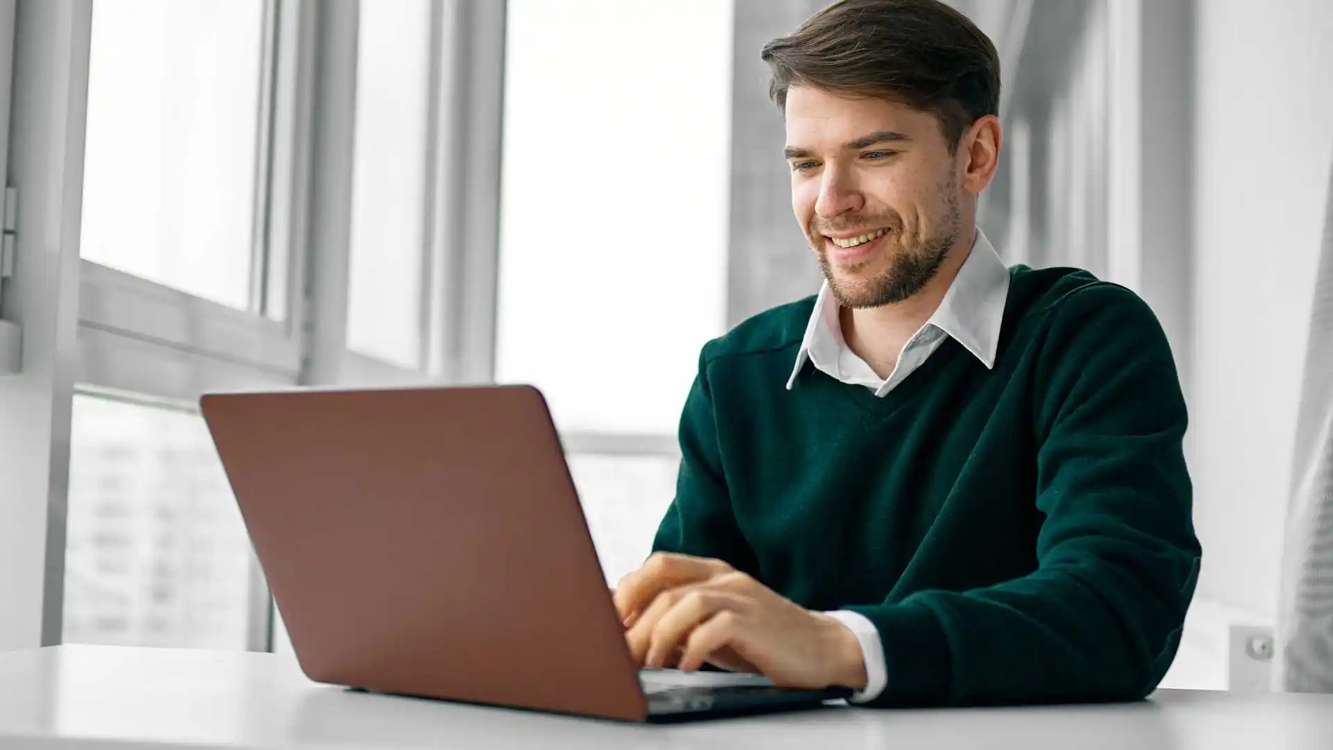 Man on laptop uploading files